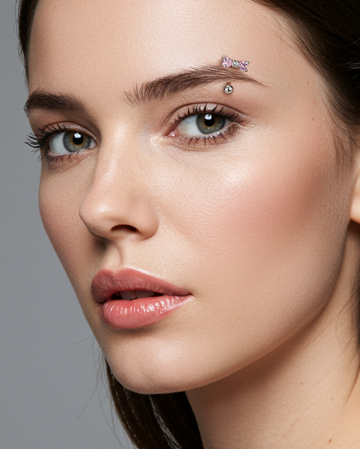 pink bow eyebrow piercing