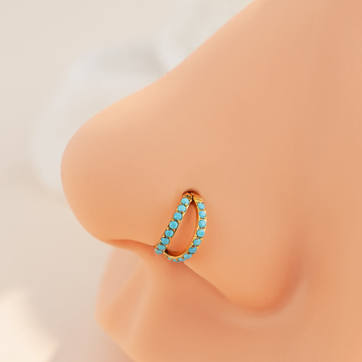 gold turquoise nose piercing