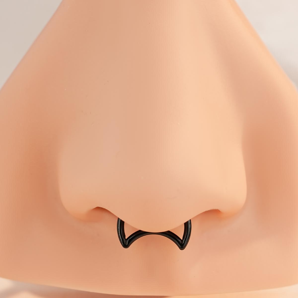 black crescent moon septum piercing