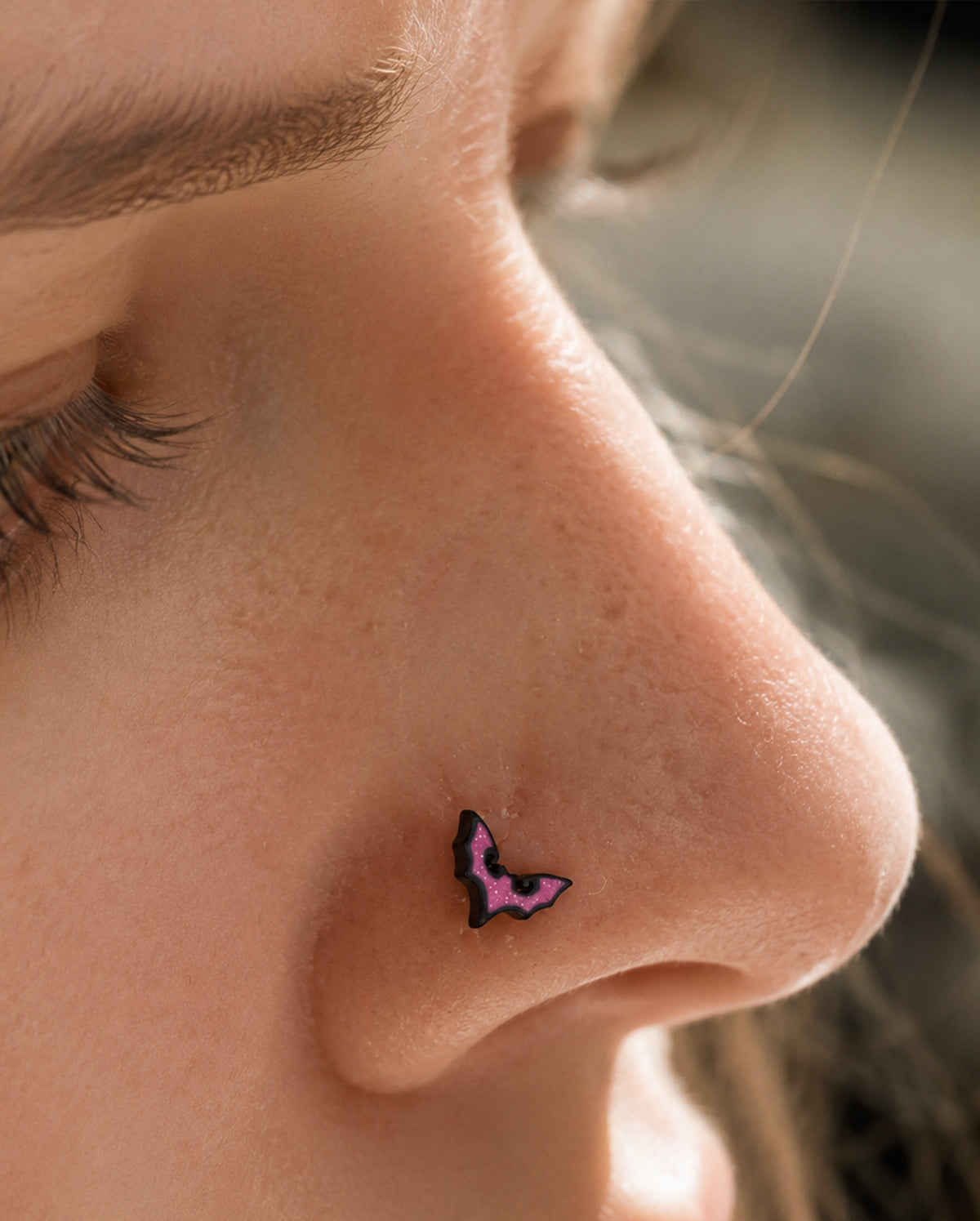 pink bat nose piercing