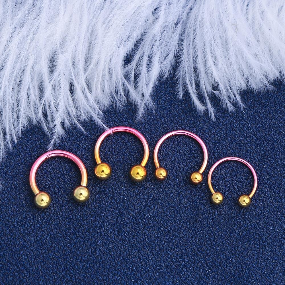 pink and yellow horseshoe septum rings